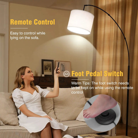 Woman using remote for arc floor lamp with foot switch, 81-inch tall dimmable LED standing light in living room.