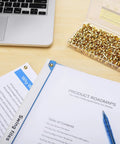 Top Tier Golden Brass Paper Fasteners For Scrapbooking And Handmade Craft Jobs 250 Piece Bulk Pack shown with documents and laptop.