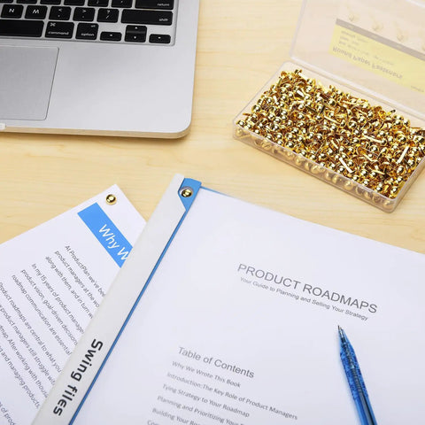 Top Tier Golden Brass Paper Fasteners For Scrapbooking And Handmade Craft Jobs 250 Piece Bulk Pack shown with documents and laptop.