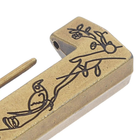 Close-up of zinc alloy Old School Vintage Hasp Lock With Key And Screws For Jewelry Boxes And Storage Chests with artistic engraving.