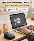 Slick Wireless Bluetooth Label Maker With Smooth Wide Format Printing And Included Tape Roll For No Fuss Home Organization Small Biz Branding And School Supplies in use with a laptop.