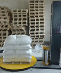 Automatic Pallet Wrapping Machine For Industrial Loads Heavy Duty Stretch Film Wrapper System in warehouse with stacked pallets