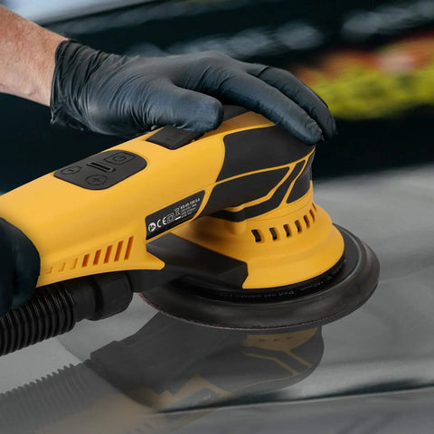 Kickin Up Dust Free Surfaces With This Beefy Electric Random Orbital Sander That Features Shop Vac Hookup Plug In Cord And Sharp Ceramic Discs For Tight Woodworking Jobs with a close-up of a user's hand on the tool.