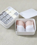 Stackable White Plastic Drawer Organizers For Bras Socks And Underwear Open Top Storage Bins with sorted bras and socks.