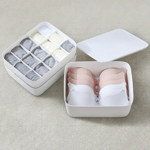 Stackable White Plastic Drawer Organizers For Bras Socks And Underwear Open Top Storage Bins with sorted bras and socks.