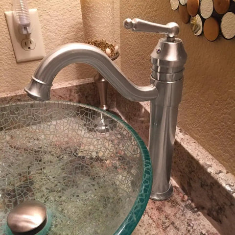 Century Single Lever Vessel Faucet in Brushed Nickel with Dope Solid Brass Build next to a glass vessel sink