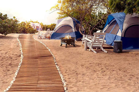 No Mess Smokeless Round Propane Fire Pit For Outdoors with tents and chairs on a sandy beach campground