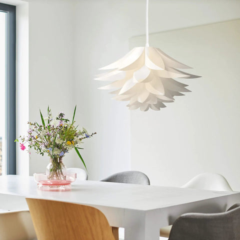 Dope Puzzle Pendant Lamp Shade Lotus Flower DIY Jigsaw Kit hanging above a modern dining table in a bright room.