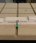 Wooden stock pieces secured with screws on a workbench demonstrating fitting for Half Inch By Fourteen Inch Two Step Plunge Router Bit.