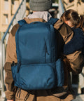 Dad with child wearing Dad Friendly Diaper Bag Backpack With Dual Compartments And Removable Cooler, Rugged And Water Resistant.