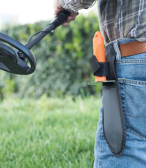 Person wearing the Prospector's Serrated Edge Digger Compact Shovel Trowel with belt loop sheath for gardening and metal detecting