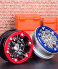 Beefed-Up RC Car Repair Kit With 24-Piece Hex Socket Screws, Spiked Hexagon Bolts And Screwdriver For SCX10 D90 And TRX4, Fits 1/10 And 1/8 Scale, Durable Metal Upgrade Parts For Secure Wheel Hubs And Suspension: close-up of red and blue RC wheel hubs with spiked bolts