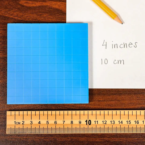 Wooden Meter Stick For Classroom Use With Inches On One Side And Centimeters On The Reverse Hardwood Construction With Clear Lacquer Finish A Kid Friendly Tool For Early Math And Geometry Concepts In Class on table with grid and paper