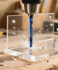 CNC router bit, blue 1/8-inch spiral upcut, installed in a drill cutting clear acrylic board