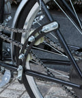 Close-up of Beefed Up Chain Tensioner And Arch Idler Kit for motorized bicycles and 2 stroke engines on bike frame.