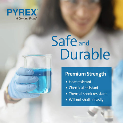 Close-up of a gloved hand holding a Pyrex beaker filled with blue liquid, highlighting safety and durability features.