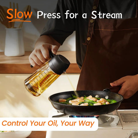 Game Changing Glass Olive Oil Sprayer For Cooking, 16 Oz Dual Pump Dispenser Bottle, Ultra Fine Mist Shaker For Salads And Air Fryer Accessory, Zero Spill BBQ Grill Spray Can With Secure Cap, Matte Black in use to drizzle oil over vegetables.