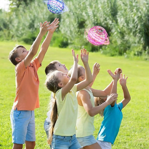 Children playing outdoors with 2025 Upgraded Flying Orb Ball Toy With Hover Boomerang Spin Mini Drone, enjoying colorful orbs.