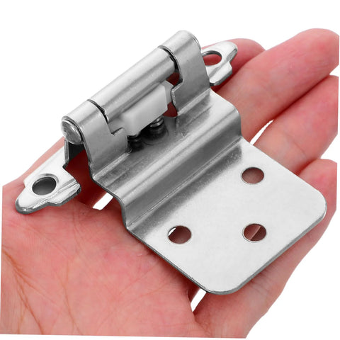 Hand holding self-closing recessed cabinet hinge showing metal durability and design.