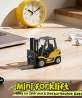 Mini RC Forklift 1 to 64 Scale Alloy Toy With App Programmable Path And Bluetooth Remote Control on desk with accessories.