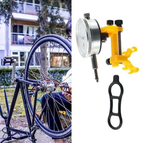 Cyclist using Pro Bike Wheel Truing Stand And Rim Adjustment Tool alongside a dial gauge and wrench