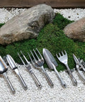 Assorted gardening tools on display, including Durable Aluminum Alloy Garden Weeder Fork Handy Hand Tool With Ergonomic Grip For Planting And Weeding Lightweight And Easy To Use Ideal For Yard Lawn And Farm Mulching Tilling And Soil Loosening Silver