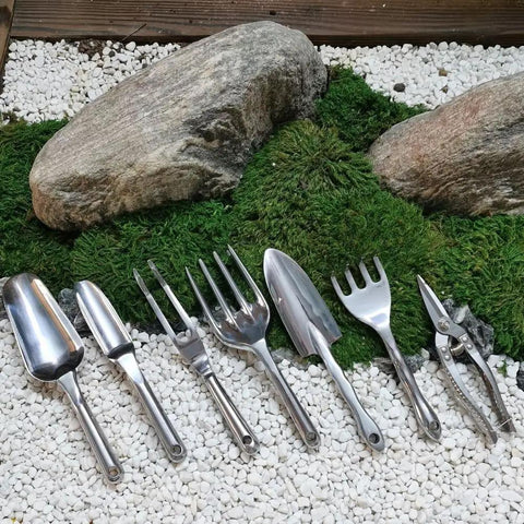 Assorted gardening tools on display, including Durable Aluminum Alloy Garden Weeder Fork Handy Hand Tool With Ergonomic Grip For Planting And Weeding Lightweight And Easy To Use Ideal For Yard Lawn And Farm Mulching Tilling And Soil Loosening Silver