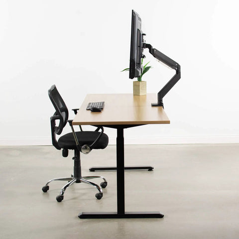 Built Tough VESA Adapter Bracket For TVs And Monitors Max 42 Inches on a desk with a monitor, plant, and black chair.