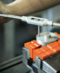 6 Inch TPU Soft Jaw Pads For Bench Vise With Magnetic Grip, Multi Groove Textured Inserts For Woodworking Metal And Plastics, Orange Pair, shown gripping a metal piece in a vise during use.