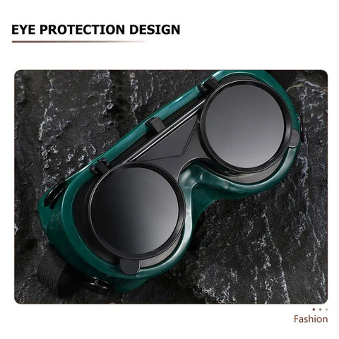 Four Pack Heavy Duty Welding Safety Goggles With Anti Scratch Coating And Double Flip Up Lenses For Solid Rugged Industrial Eye Protection And Harsh Arc Blocking, shown from above on rocky surface.