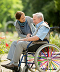 Wheelchair with 180 Pcs Spoke Skins And Covers In 10 Dope Color Mix for decoration and protection in a garden setting
