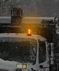 30 Led Amber Forklift Strobe Light 30W Heavy Duty Vehicle Safety Beacon mounted on snow-covered truck in a blizzard.