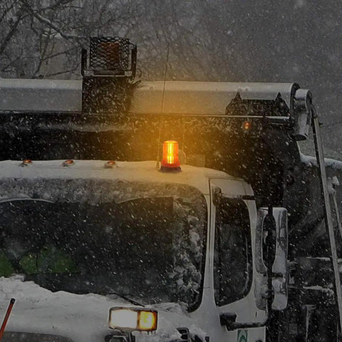 30 Led Amber Forklift Strobe Light 30W Heavy Duty Vehicle Safety Beacon mounted on snow-covered truck in a blizzard.