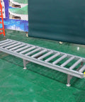 Super Heavy Duty Modular Conveyor Rollers And Connectable Discharge Chutes With Smooth Metal Roller Slide Kit For No Sweat Warehouse Dumping And Quick Truck Bed Unloading Rock Solid 5 Piece Pack Silver - metal conveyor rollers on a green floor.