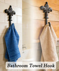Top Shelf Single Piece Heavy Duty Cast Iron Wall Hook With Screws Vintage Coat Hanger Organizer For Scarves Bags Towels Keys Cap Rustproof Badass Home Decor Accessory with blue and beige towels.