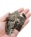 Sixty Piece Bronze Mini Cabinet Hinges With 240 Mounting Screws One Inch Iron Corner Fitting For Drawers And Jewelry Boxes in hand.