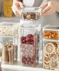 Straight Up Solid Game Changer For Your Kitchen Pantry Clear Airtight Glass Coffee Jar With Matching Spoon And Stand Sealed Food Container For Spices Or Grains with assorted dried foods.