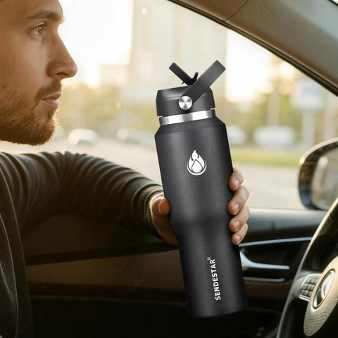 Smooth Operator 40oz Stainless Steel Vacuum Insulated Water Bottle With Straw And Spout Lids Kept Ice Cold For Two Full Days Fits Every Car Cup Holder For Weekend Drifts Summer Vibes And Travel Black in hand inside car.