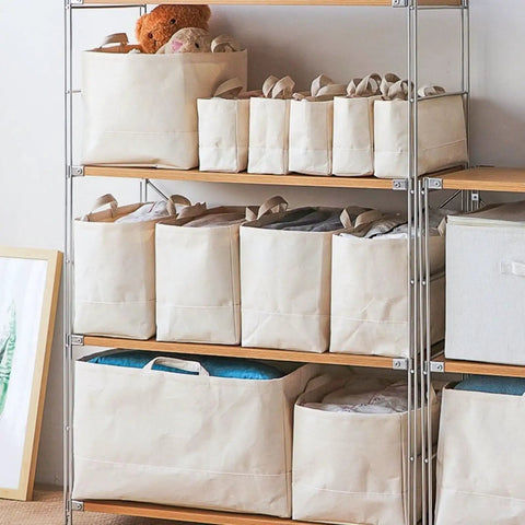 Slim Fabric Storage Bins With Comfort Handles Narrow Closet Organizers For Shelf And Cabinet Durable Canvas Containers stacked on wooden shelves.