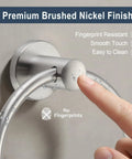Close-up of brushed nickel towel ring stainless steel round bath holder with finger showing rustproof durable finish