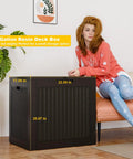 Front view of 35 Gallon Resin Deck Box Outdoor Storage Chest For Patio Furniture Cushions Tools Garden Gear And Pool Supplies Waterproof Lockable Weather Resistant Bin For Backyard Organization And Clutter Control with woman seated next to it.