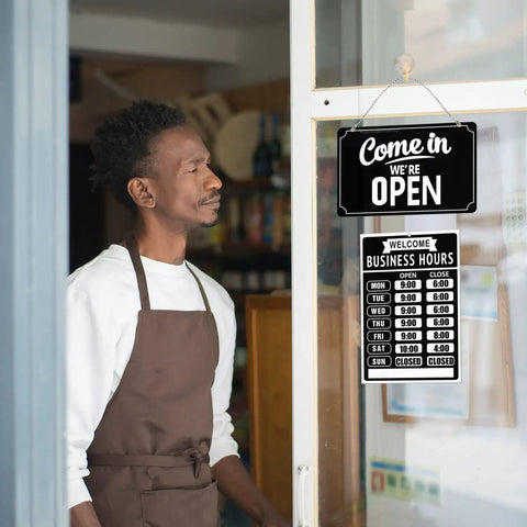 Open Closed Sign Set With Business Hours Flip Sign For Window And Door Includes Vinyl Sticker Pack Eye Catching Open For Biz And Closed Messages Perfect For Store Restaurant Or Bar Black displayed on cafe door with owner.