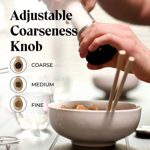 Adjustable coarseness knob on Must-Have Salt and Pepper Grinder Set With Stand, Glass Body Grinders, in use over a bowl.