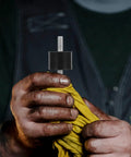 Four Piece Built For The Grind Anti Vibration Rubber Studs M10 Double Screw Mount held with yellow cloth in a hand.
