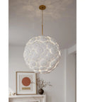 Contemporary Coastal 9 Light Pendant Featuring Legacy Brass Finish And Clean White Ceramic Shades in elegant living space.