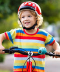 Child riding bike with 2 In 1 Kids Bike Lights And Horn Set For Night Rides, Rechargeable Headlight And Tail Light attached to handlebars.