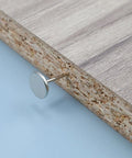 Heavy Duty Flat Head Upholstery Tacks For Furniture Repair And Craft Rooms Packs Two Hundred Silver Iron Thumb Pins embedded in wood.
