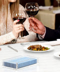 Crystal Clear Acrylic Napkin Holder Tray With 8mm Thick Build on a dining table setup with couple toasting wine glasses