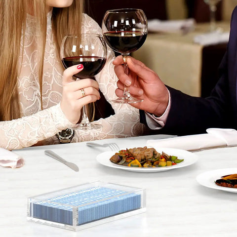 Crystal Clear Acrylic Napkin Holder Tray With 8mm Thick Build on a dining table setup with couple toasting wine glasses