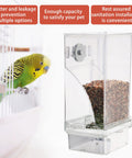 Hassle Free Automatic Bird Feeder With No Mess Clear Acrylic Bowl And Smooth Cage Mount For Parrots Canaries Cockatoos No Sweat Setup Foraging Snack Station 2 Pack, showing feeder with seeds and a budgie.